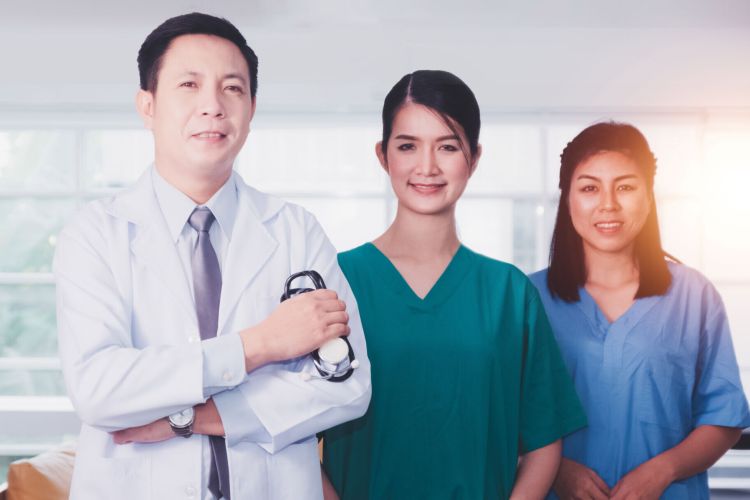 Team Asian doctor and Nurse Standing confident hospital background
